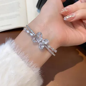 Detail view of an elegant double-layered zircon butterfly bangle with delicate pearl accents.