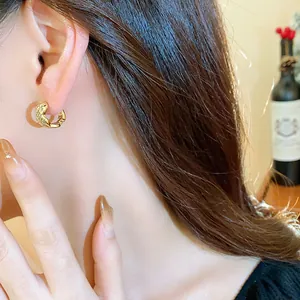 Detailed view of elegant 18k gold plated square zircon hoop earrings worn by model