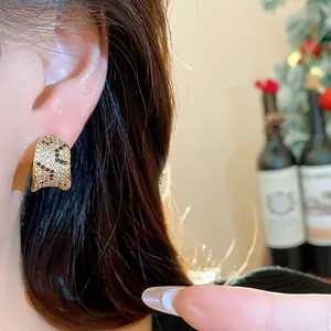 Detail view of a luxury 18k gold plated square hoop earring with sparkling zircons