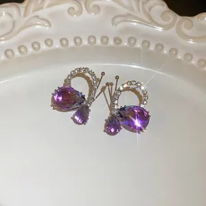 Purple butterfly teardrop earrings with sparkling crystal accents and silver needles.