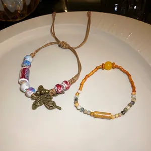 Vintage ethnic style woven bracelet with ceramic beads and butterfly charm for women