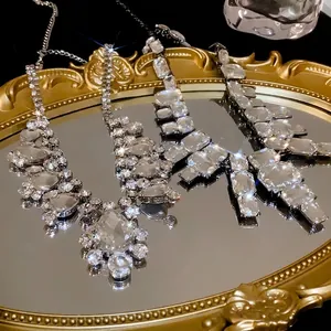 Statement crystal choker necklaces displayed on a golden vintage mirror tray backdrop