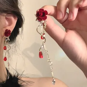 Detailed view of red rose dangle earrings with pearls and crystal drops for a romantic look