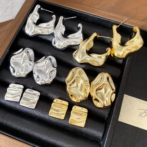 Collezione premium di orecchini a lobo in metallo irregolare in finitura oro e argento.