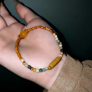 Close-up of vintage ethnic style beaded bracelet with ceramic bamboo beads and yellow stone