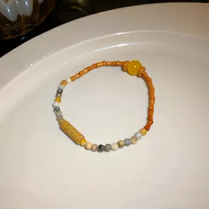 Detailed view of a vintage ethnic style beaded bracelet with ceramic and stone beads.