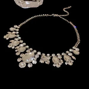 Detailed view of glamorous statement necklace with teardrop and round rhinestones