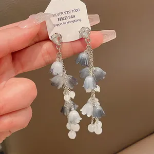 Vue détaillée de boucles d'oreilles élégantes en forme de muguet avec aiguilles d'argent.