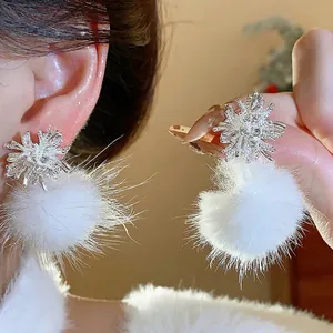 Elegant firework snowflake earrings with fluffy white fur balls, perfect for winter