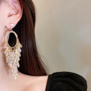 Detailed macro view of elegant crystal tassel drop earrings with sparkling gold rhinestones