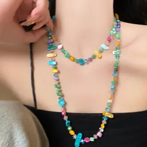 Close-up detail of retro ethnic layered necklace with colorful irregular glass beads.