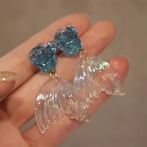 Handmade blue rose stud earrings with iridescent translucent mermaid tail charms