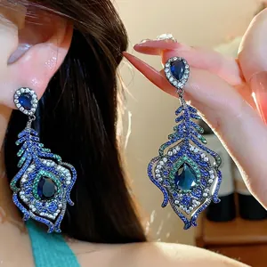 Elegant vintage court style peacock feather earrings with sparkling blue zircons and silver studs
