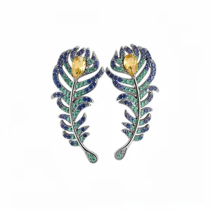 Elegant vintage peacock feather stud earrings with colorful pavé crystals and yellow gems