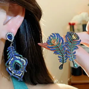 Exquisite peacock feather earrings set with vibrant blue and green cubic zirconia stones