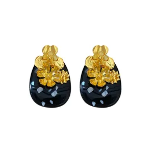 Vintage gold metal flower and black resin oval stud earrings with elegant court style