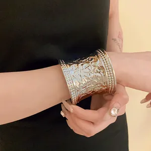 Vintage ornate gold cuff bracelet with embossed floral patterns for women