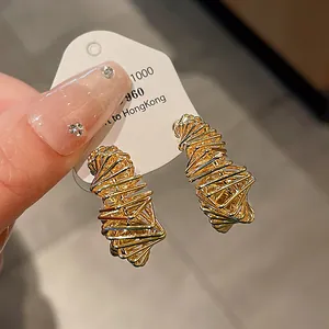 Detailed close-up showing the unique woven texture of irregular gold plated stud earrings