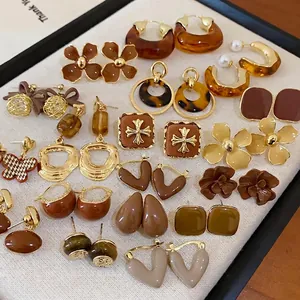 Vintage Maillard brown earring set featuring retro floral and bow designs in earth tones
