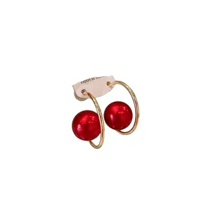 Red pearl hoop earrings with gold-tone circular frame and silver needle for women