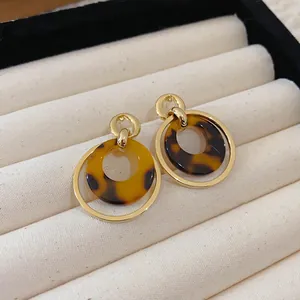 Detailed view of French vintage leopard print resin earrings in a beige velvet display box