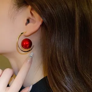 Detailed macro view of vintage red pearl circular geometric earrings for elegant women.