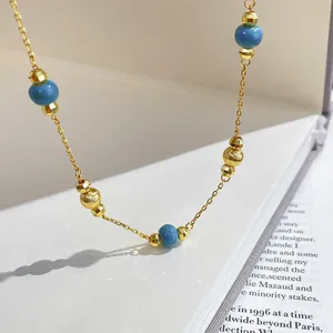 Vintage palace style gold chain necklace with blue beads and faceted gold accents.