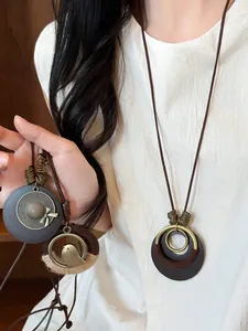 Detailed macro view of retro ethnic style Zen long necklace with bird and hat pendants