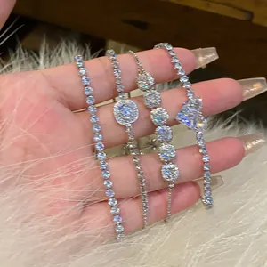 Detailed macro view of four elegant silver-tone zircon tennis bracelets with heart charms