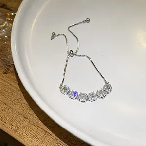Detailed close-up of a sparkling silver-toned bracelet with square zirconia clusters