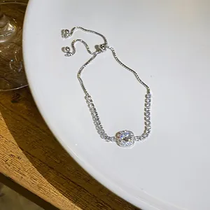 Detailed view of square zircon bracelet with adjustable sliding clasp on white plate