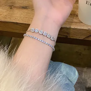 Close-up of sparkling zircon studded tennis bracelet and square cluster bracelet set
