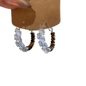 Gold-plated hoop earrings featuring tiger eye beads and sparkling cubic zirconia stones