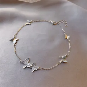 Close-up of a silver butterfly bracelet with sparkling pavé-set zirconia stones on satin.