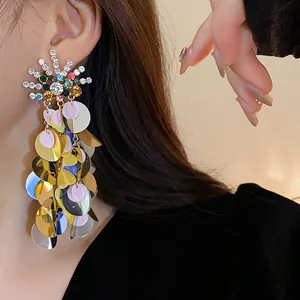 Long oversized sequin tassel earrings with colorful rhinestone sunburst sun detail