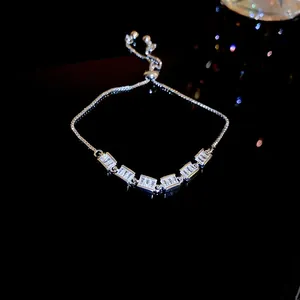 Close-up detail of an elegant silver adjustable bracelet with sparkling rectangular zircons