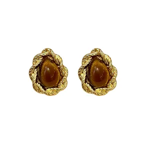 Elegant vintage Maillard style gold-toned rope earrings with teardrop resin center