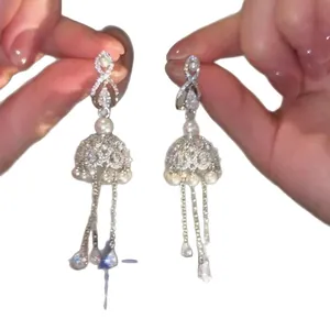 Elegant long silver tassel earrings adorned with sparkling zircons and white pearls