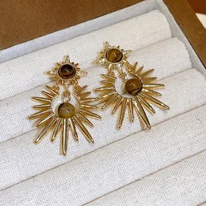 Exquisite retro gold sunburst earrings with tiger eye stones in a velvet jewelry box
