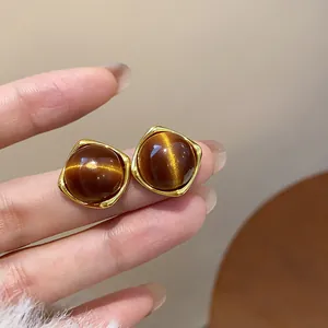 Detailed view of vintage Maillard resin stud earrings with elegant golden square borders