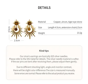 Detailed view of sun-shaped earrings with tiger eye stone and zircon material info
