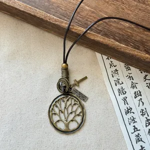 Close-up of a tree of life pendant on a vintage ethnic style long sweater necklace