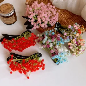 Close-up of colorful floral cluster duckbill hair clips with Mori-style aesthetic