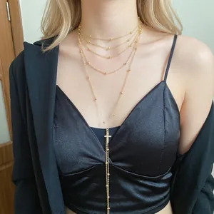 Elegant gold layered beaded chain necklace with a zircon cross pendant for women