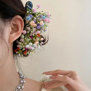 Detailed view of a vibrant multi-colored floral duckbill clip on a woman's hair.