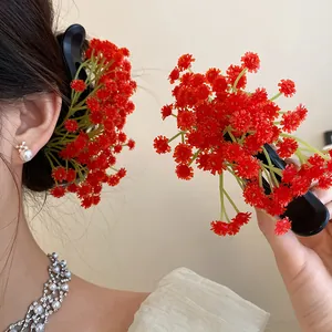 Close-up detail of a sweet red floral cluster hair clip for back of head styling.