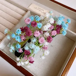Close-up detail of a colorful gypsophila flower cluster hair clip in a jewelry box