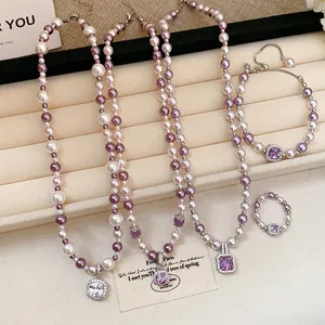 Elegant French style pearl jewelry set featuring square zircon pendants on beige tray