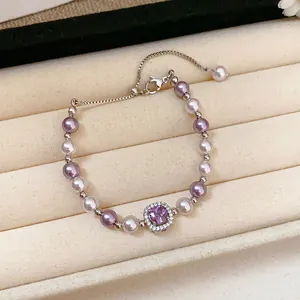 Detailed macro view of a French pearl bracelet featuring a sparkling square purple zircon