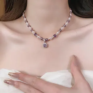 Detailed view of French pearl necklace with purple beads and square zircon pendant on model